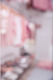 Photo of Blurred view of modern dressing room with different stylish clothes and accessories