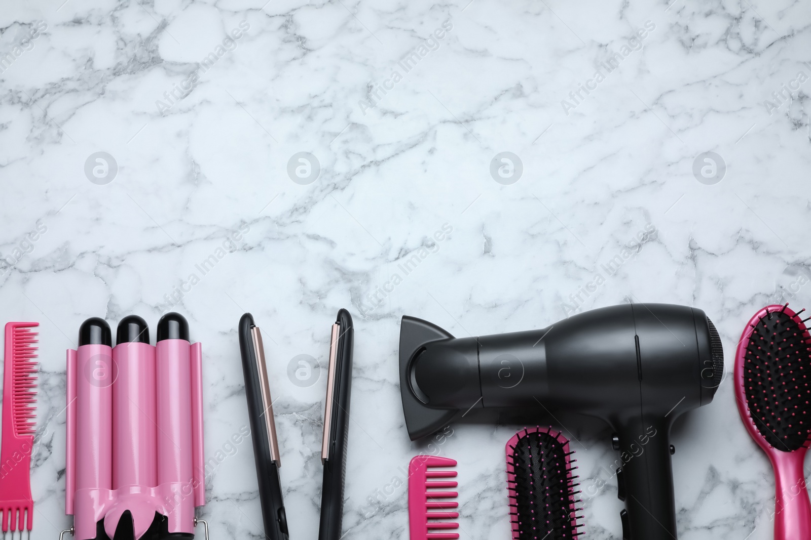 Photo of Flat lay composition of professional hairdresser tools on white marble table, space for text