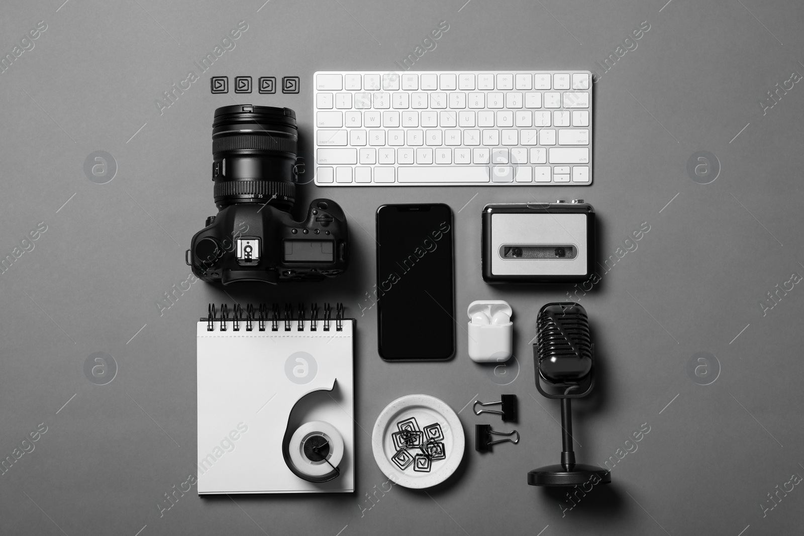 Photo of Flat lay composition with equipment for journalist on grey table
