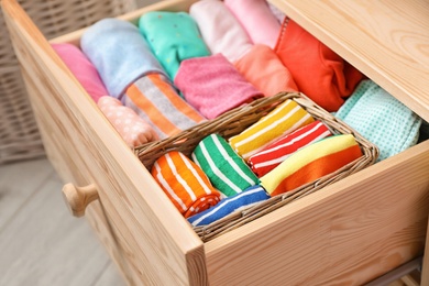 Photo of Many different colorful socks in open drawer, closeup