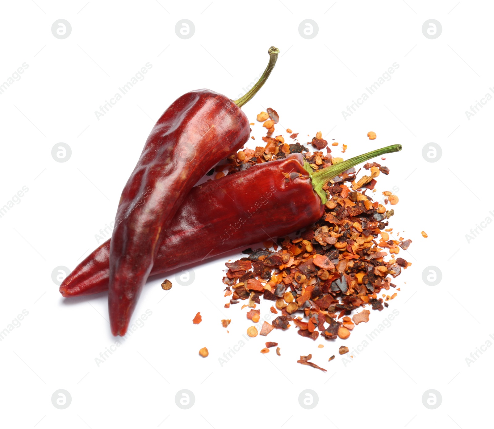 Photo of Dry chili peppers and powder on white background