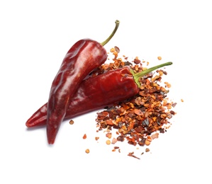 Photo of Dry chili peppers and powder on white background