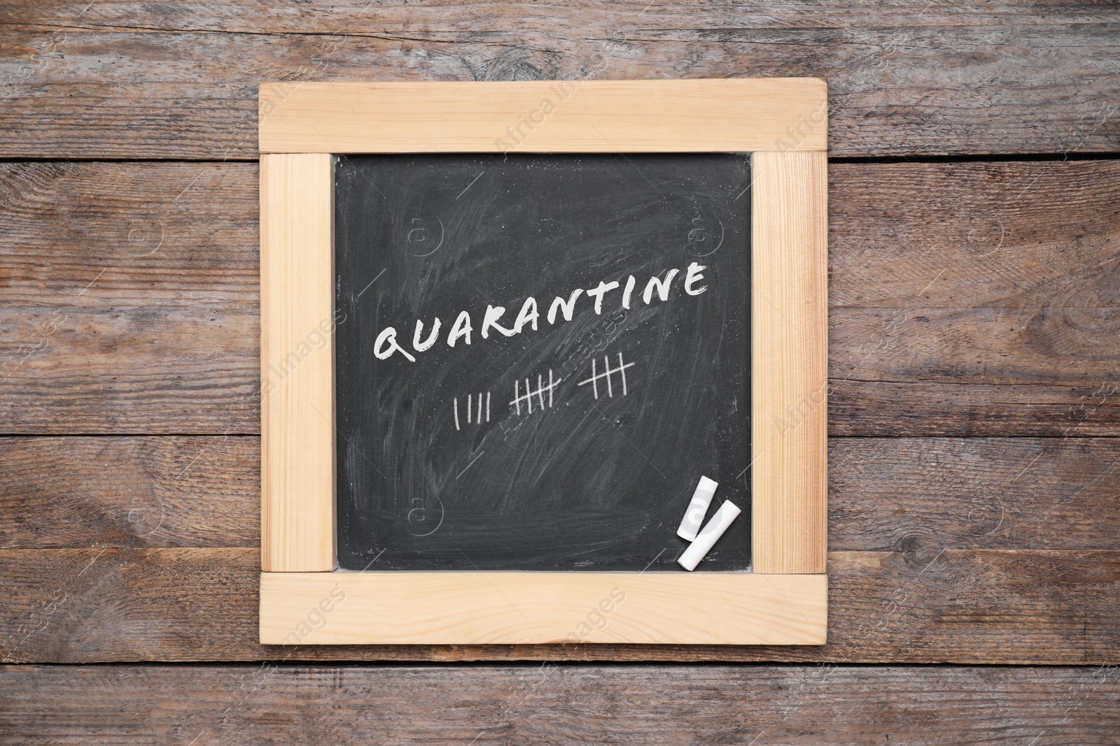 Image of Blackboard with pieces of chalk on wooden background, top view. Counting days of quarantine during coronavirus outbreak 