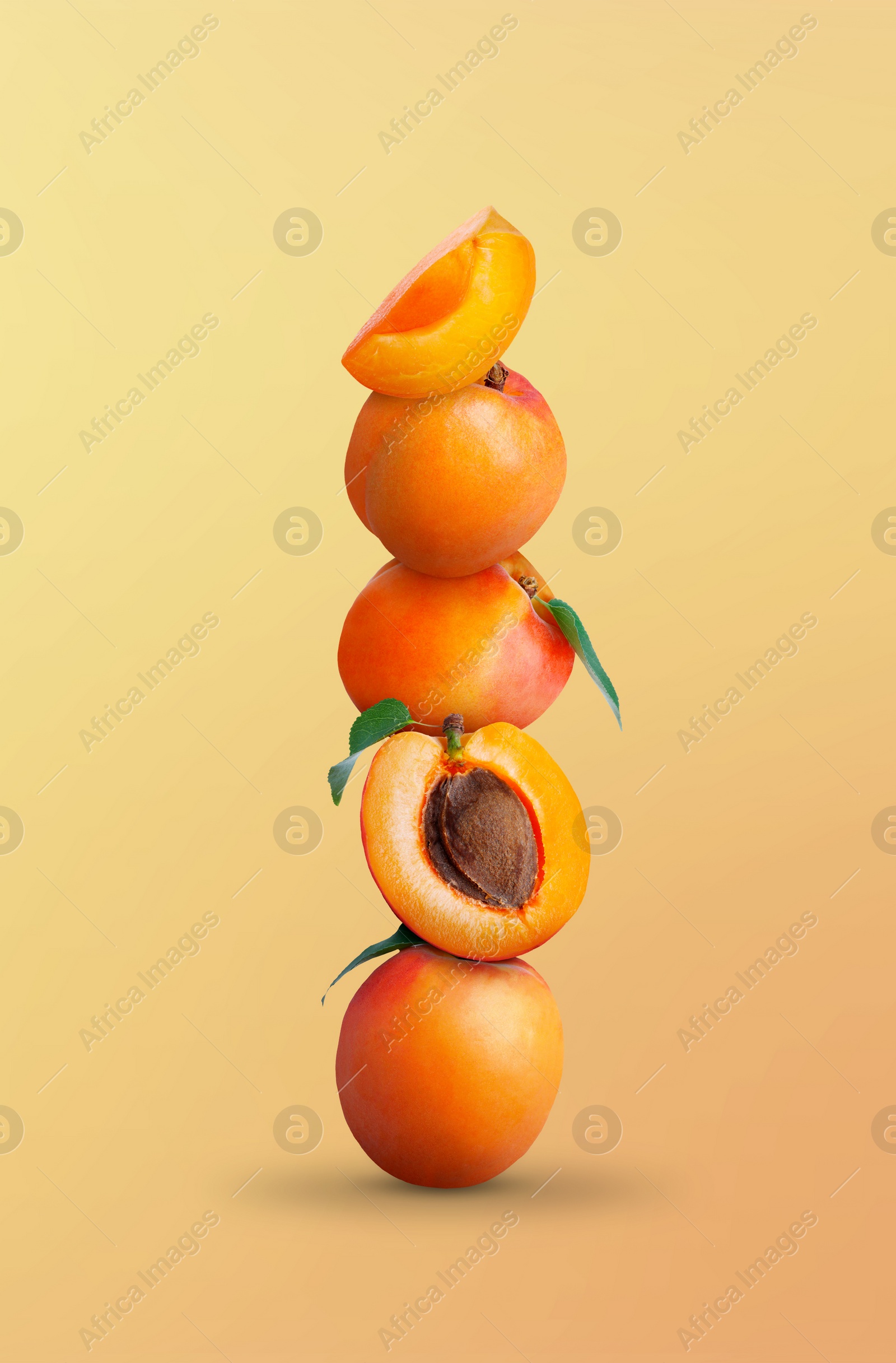 Image of Stack of fresh ripe apricots on yellow coral gradient background