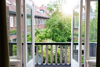 Beautiful view on balcony and inner yard with green trees from apartment