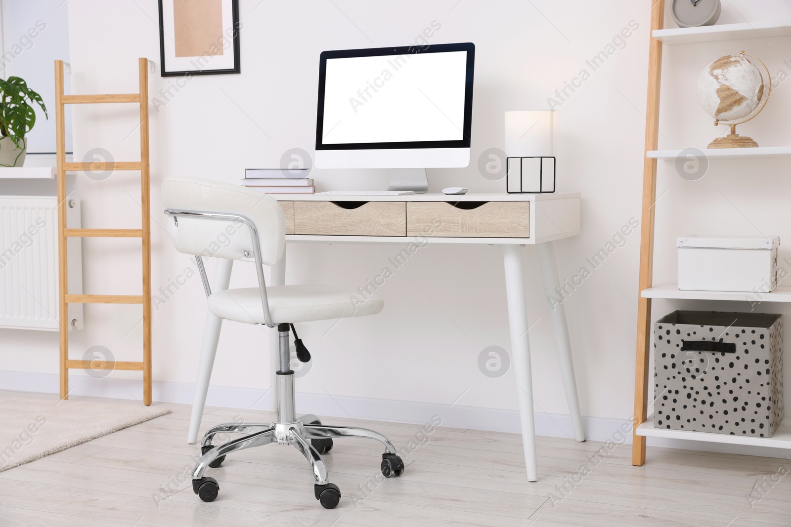 Photo of Workplace with comfortable office chair indoors. Interior design