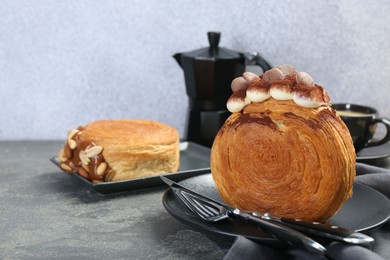 Photo of Round croissants served on grey table. Tasty puff pastry