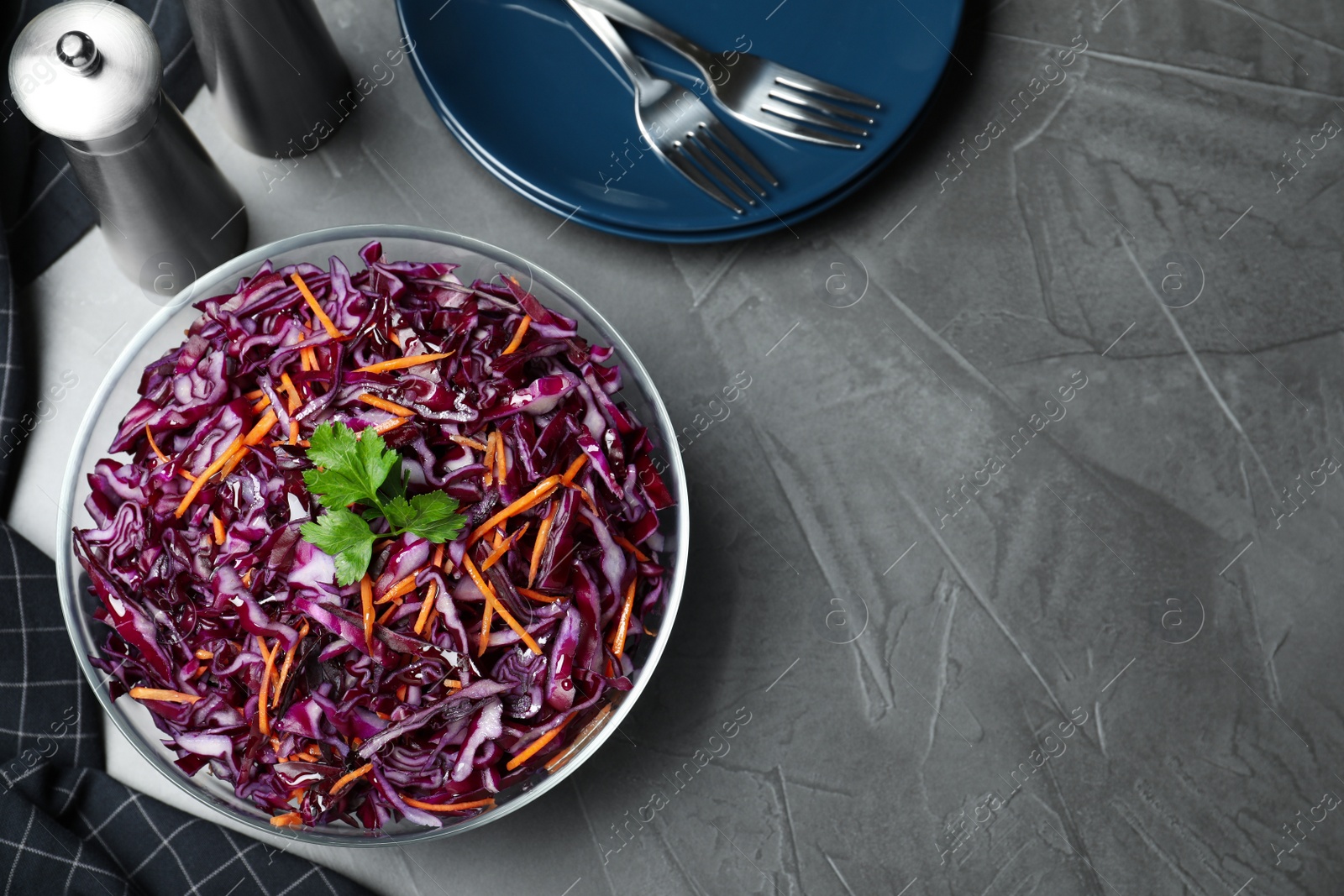 Photo of Fresh red cabbage salad served on grey table, flat lay. Space for text