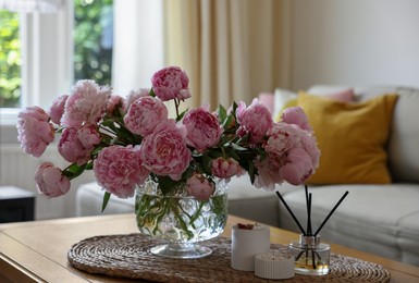 Photo of Beautiful pink peonies in vase on table at home. Interior design