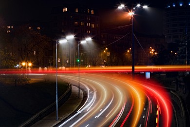 Image of Road traffic, motion blur effect. View of night cityscape with car light trails