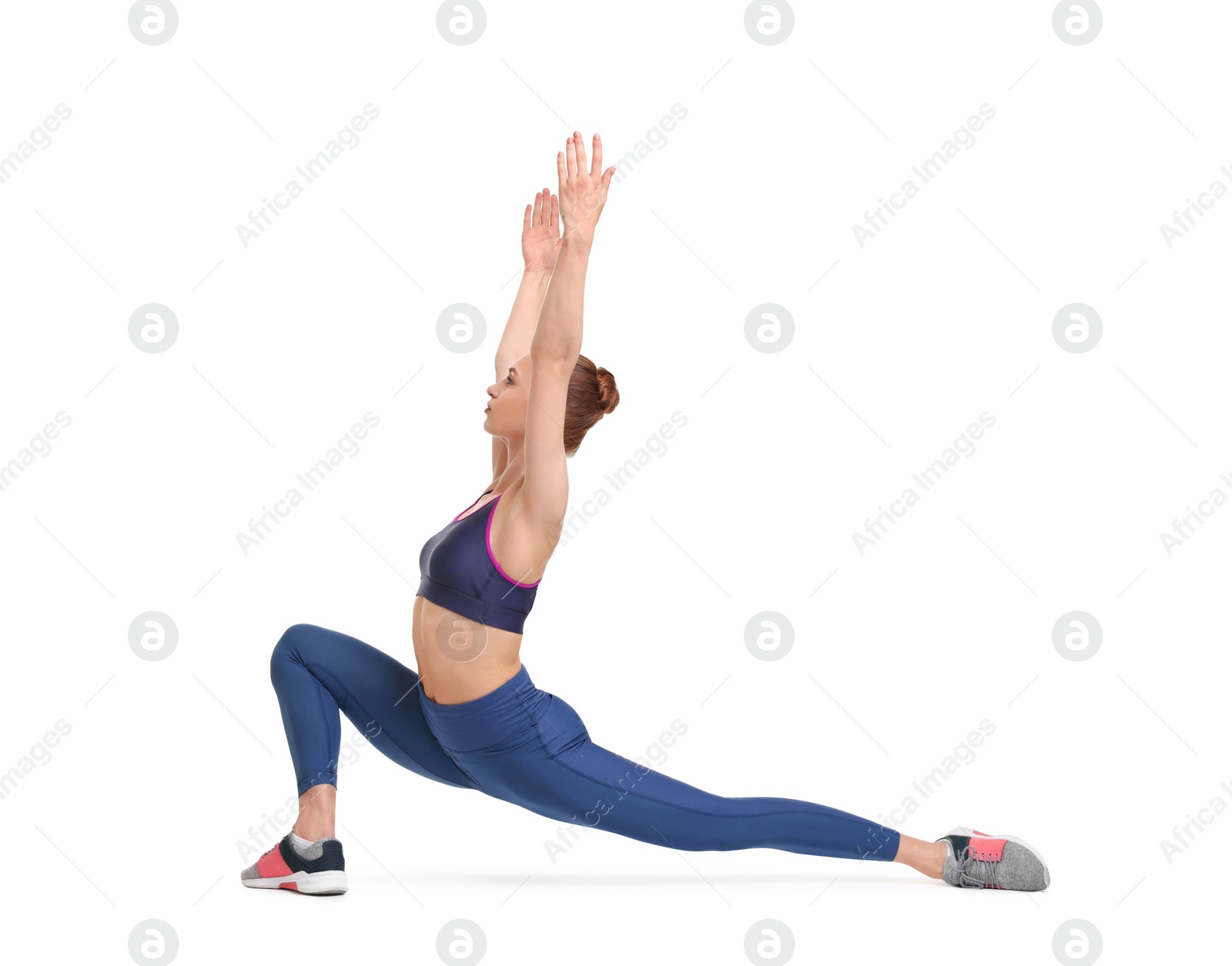 Photo of Yoga workout. Young woman stretching on white background