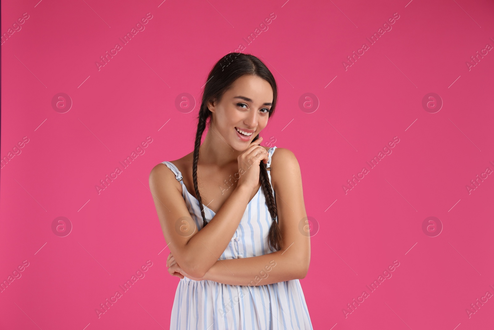 Photo of Young woman wearing stylish dress on pink background