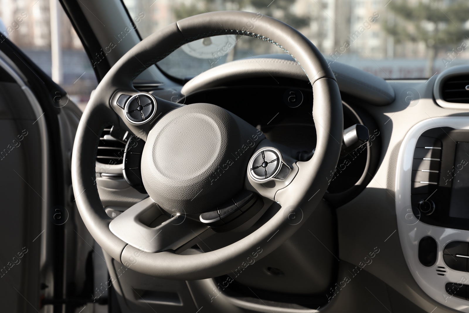 Photo of Black steering wheel and dashboard in modern car