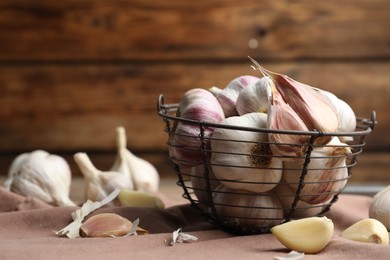Fresh organic garlic in basket on table