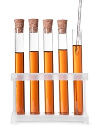 Collecting brown liquid with pipette from test tube on white background