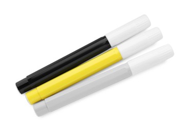 Different colorful markers on white background, top view