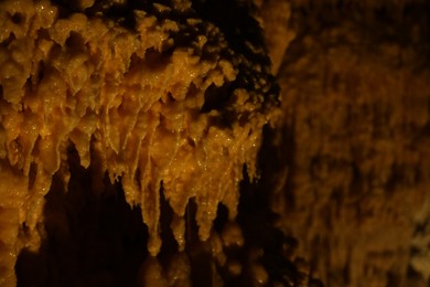 Many stalactite formations in cave, closeup view