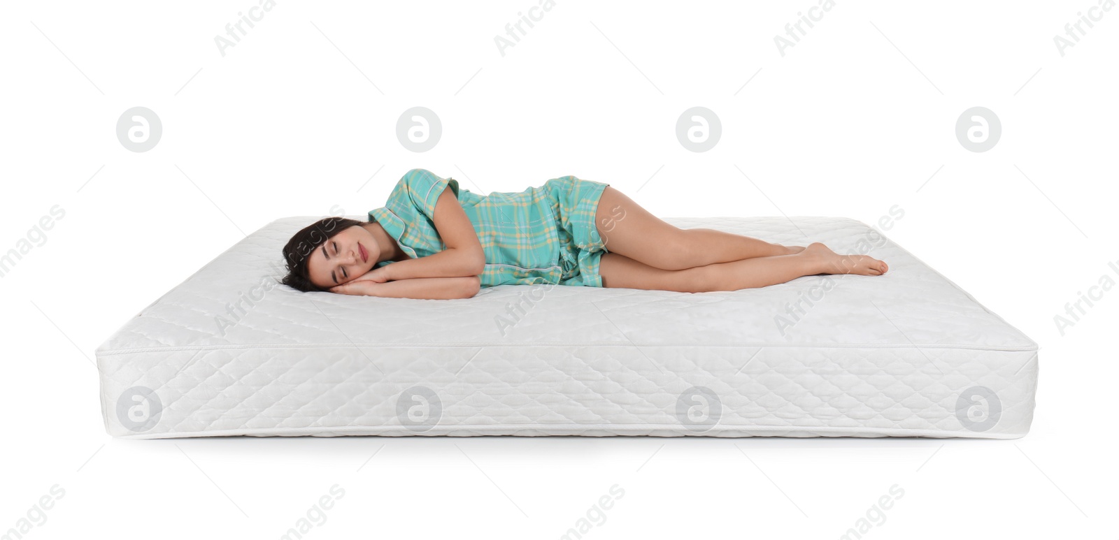 Photo of Young woman lying on mattress against white background