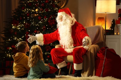Photo of Merry Christmas. Santa Claus with children at home