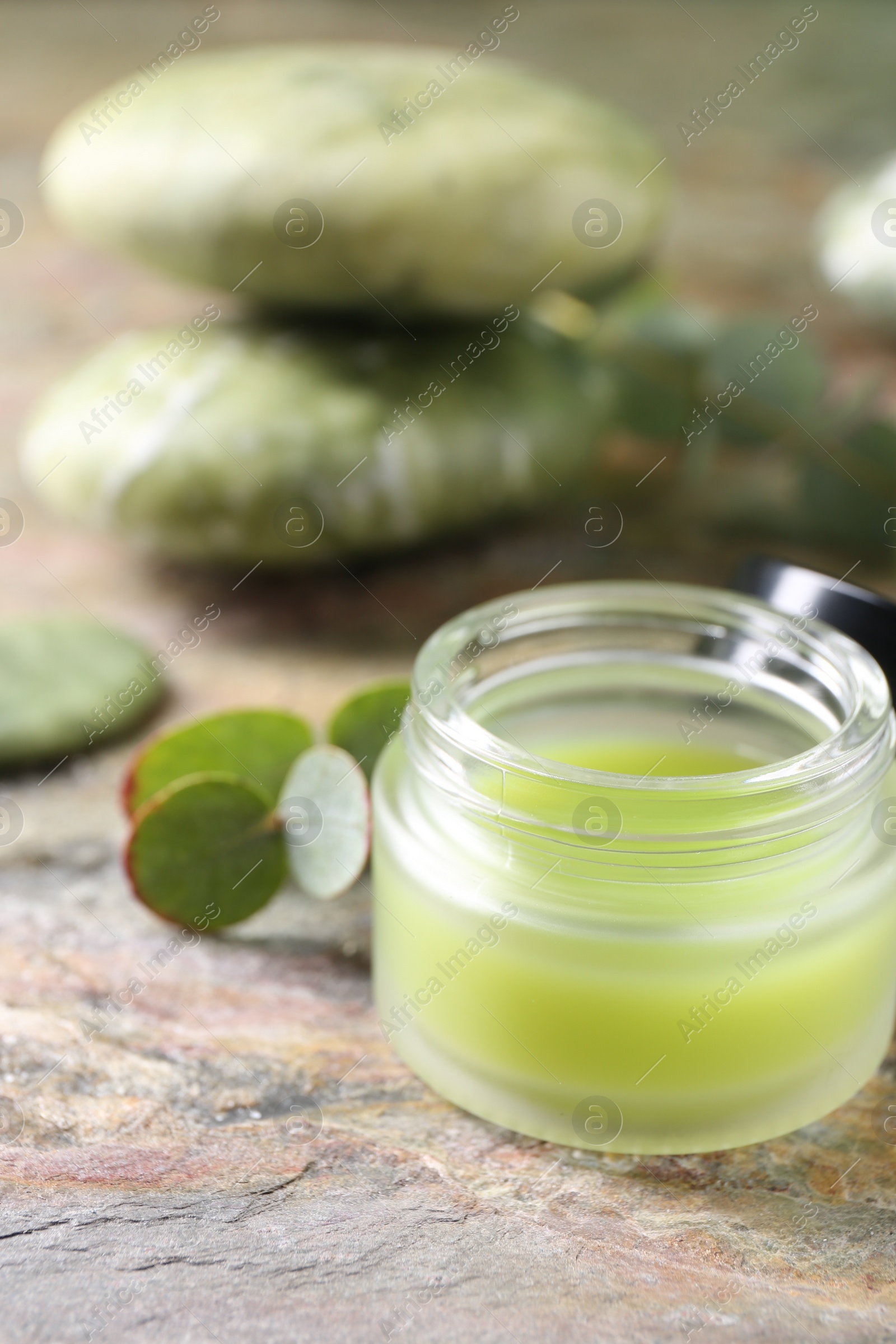 Photo of Jar of cream on textured table, closeup. Body care product