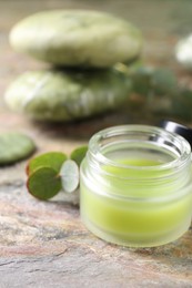 Jar of cream on textured table, closeup. Body care product