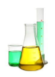 Photo of Laboratory glassware with colorful liquids on white background