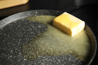 Photo of Melting butter in frying pan, closeup view