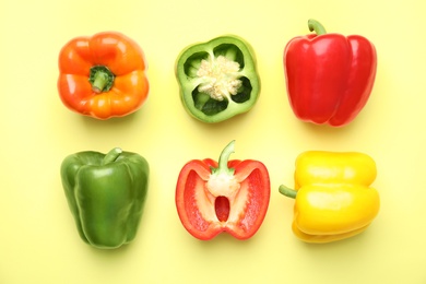 Flat lay composition with raw ripe paprika peppers on color background