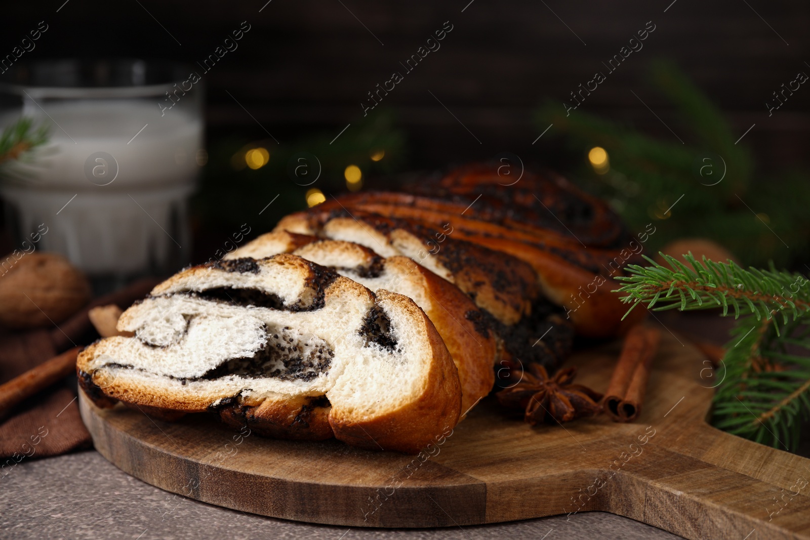 Photo of Cut poppy seed roll on textured table, closeup. Tasty cake