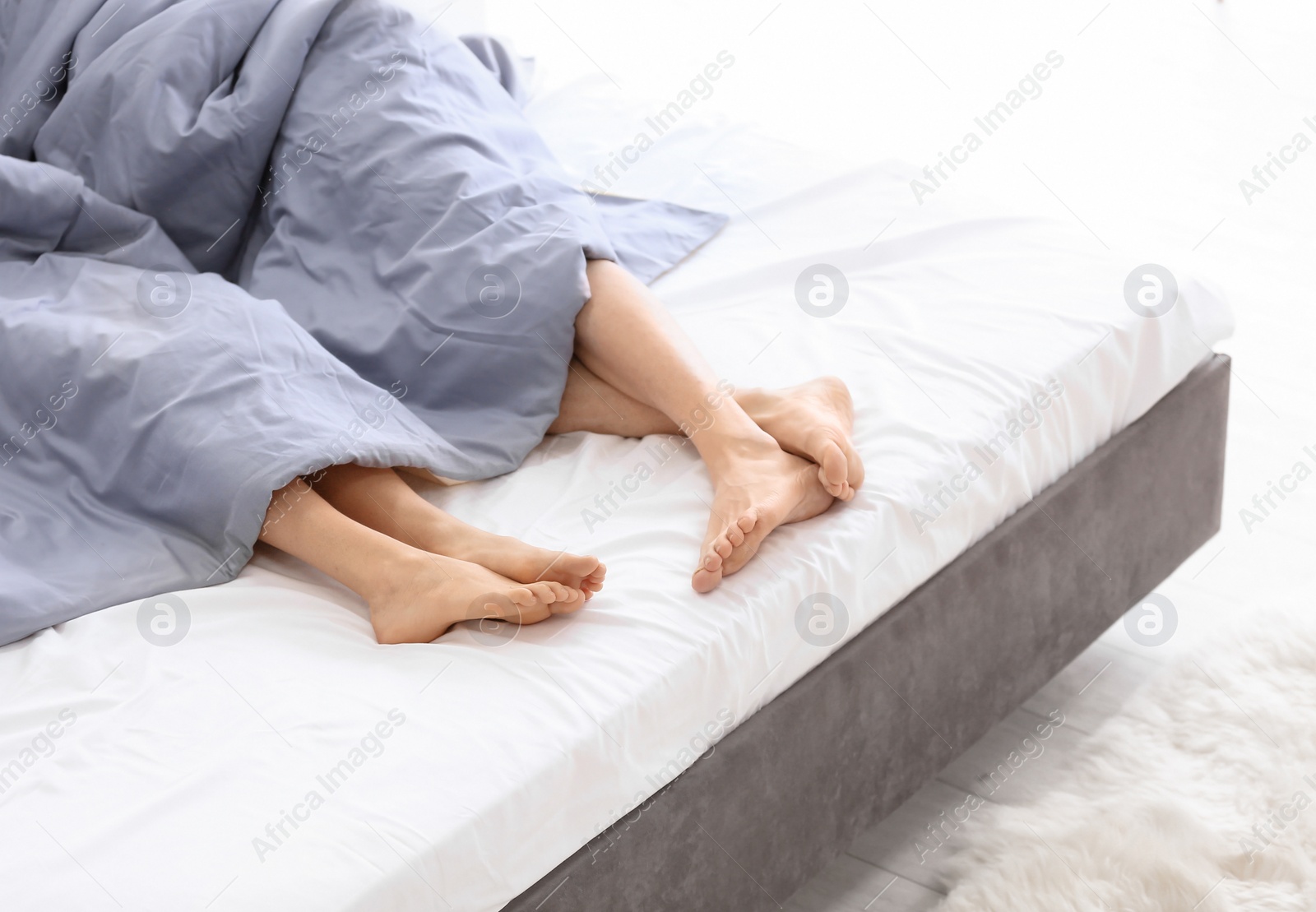 Photo of Young couple in bed at home