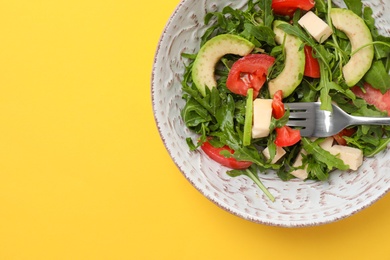 Photo of Bowl with fresh vegetable salad on color background, top view. Healthy diet