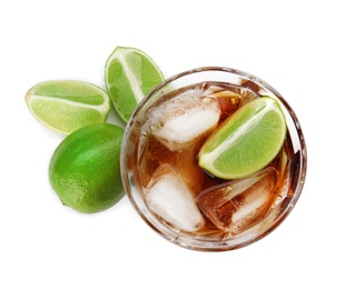 Glass of refreshing drink with ice cubes and lime on white background, top view