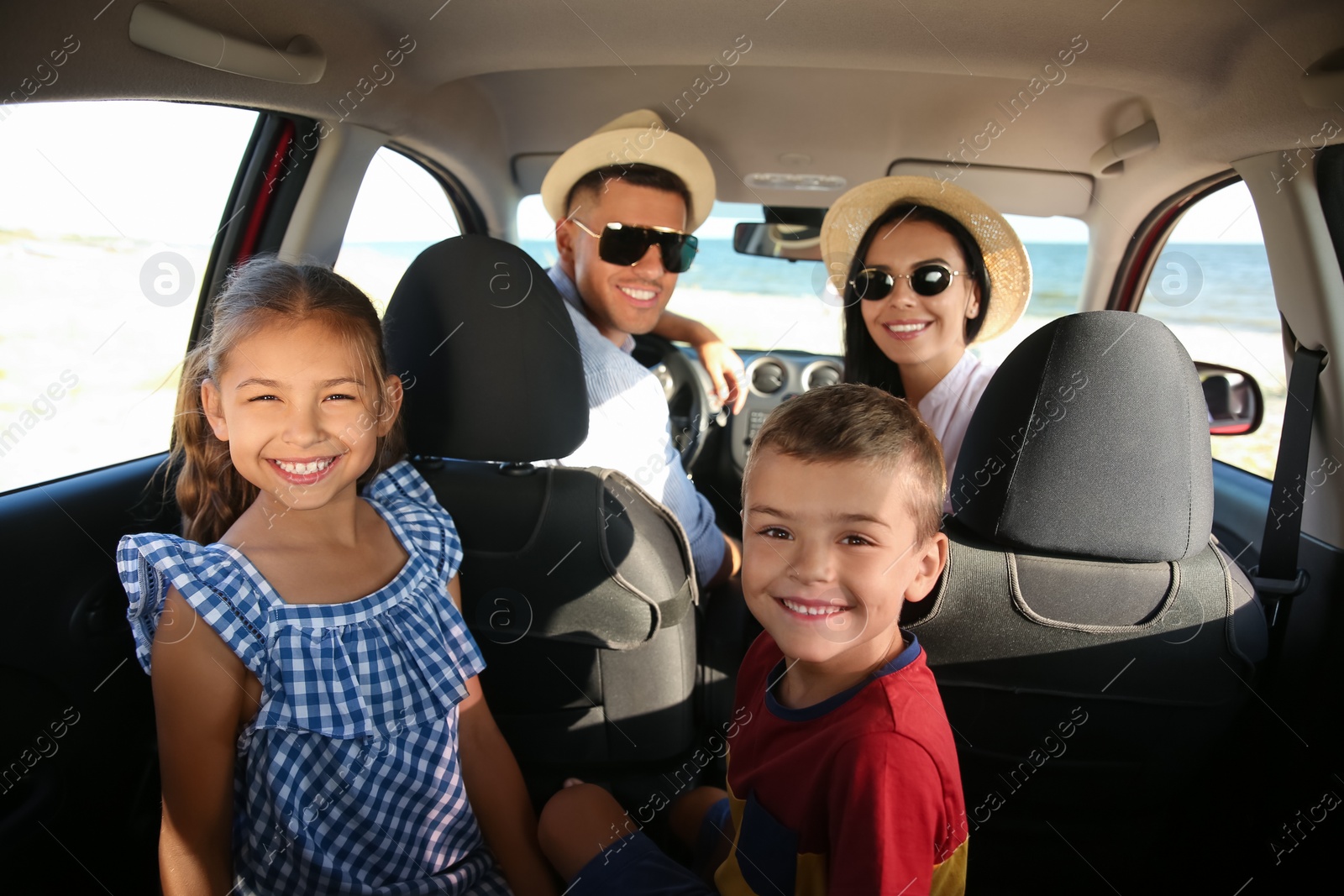 Photo of Happy family in car on road trip