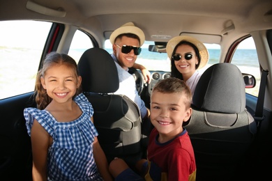 Photo of Happy family in car on road trip