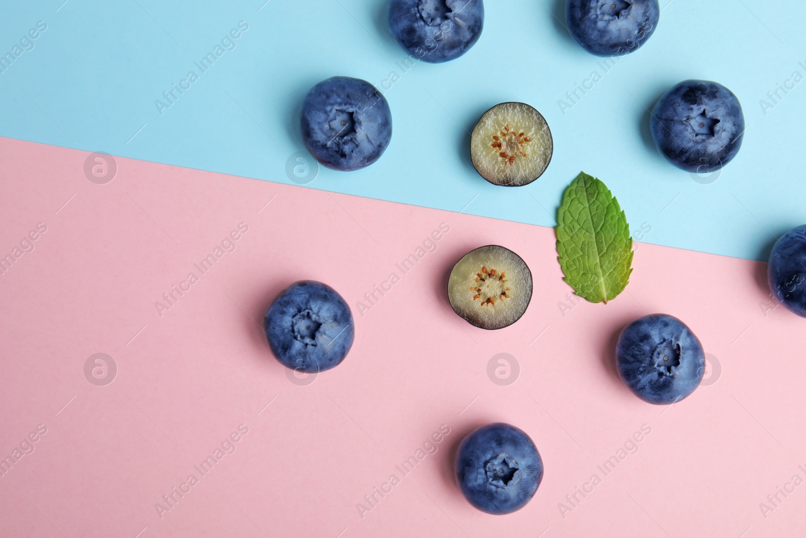 Photo of Flat lay composition with tasty blueberry on color background