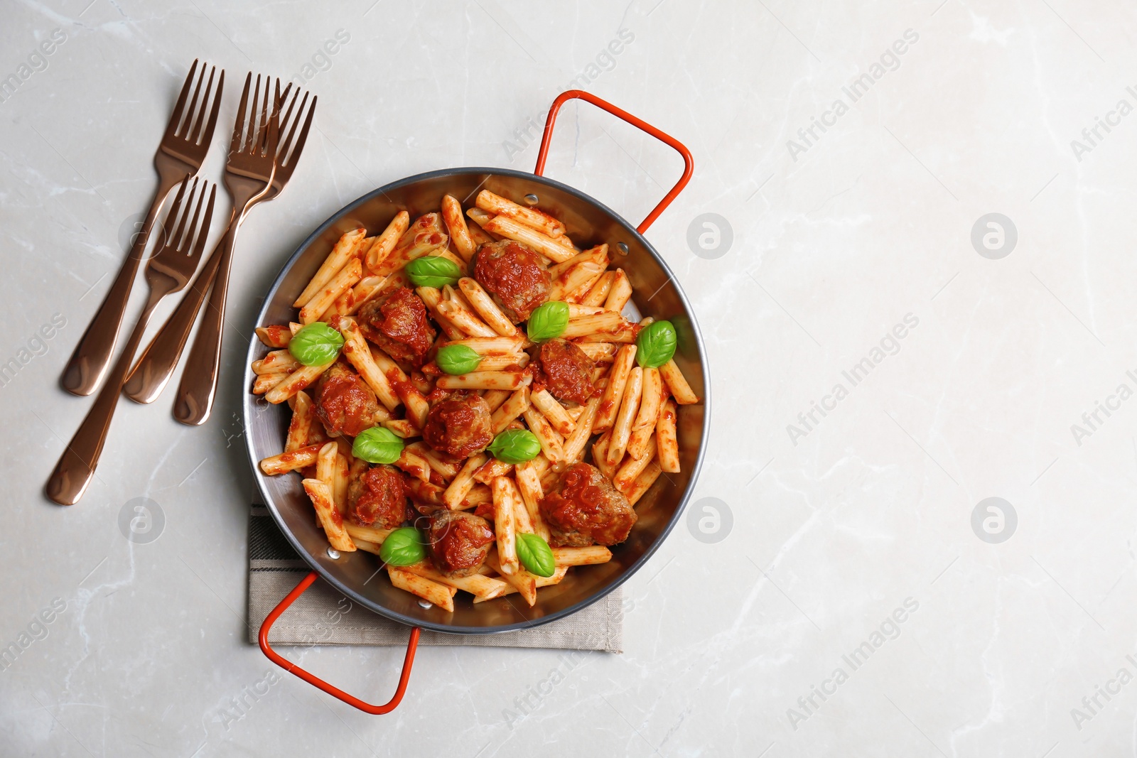 Photo of Delicious pasta with meatballs and tomato sauce on grey background, top view