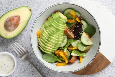 Photo of Healthy dish high in vegetable fats on light textured table, flat lay