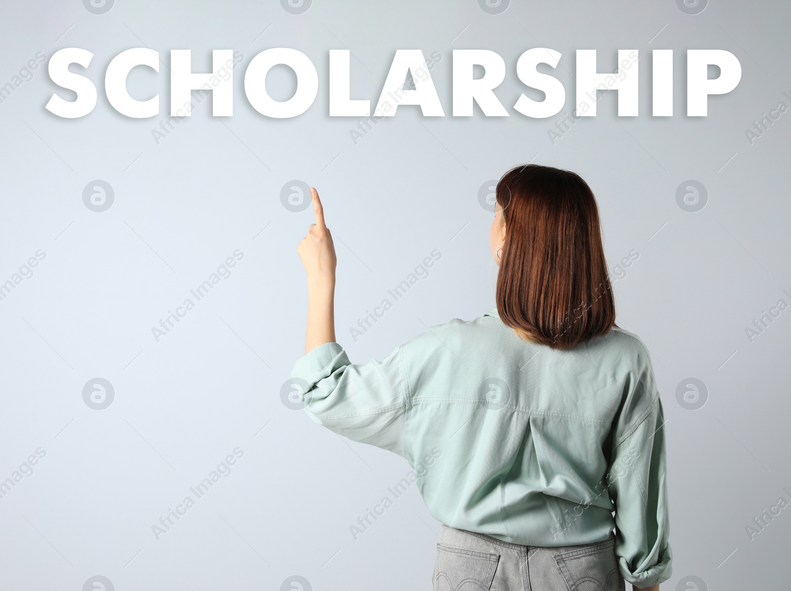 Image of Scholarship concept. Student on light background, back view