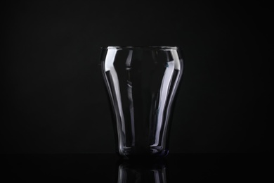 Photo of Elegant empty colorful glass on black background