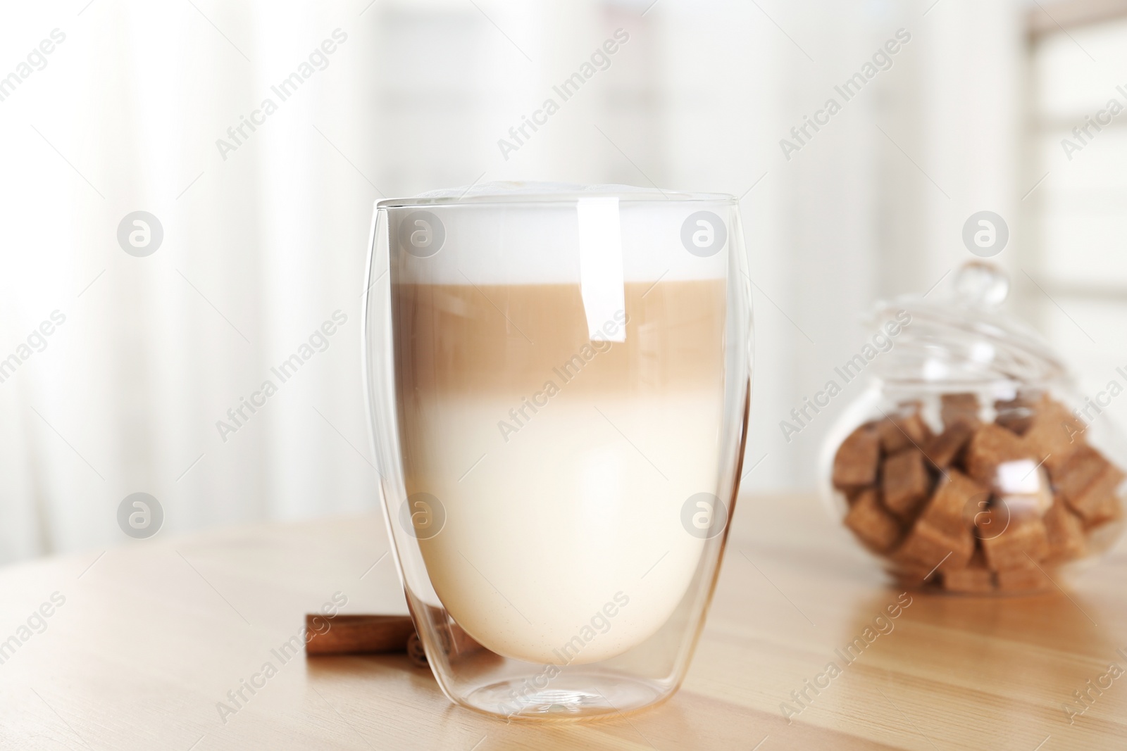 Photo of Delicious latte macchiato on wooden table indoors