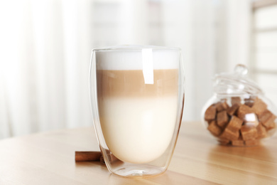 Delicious latte macchiato on wooden table indoors