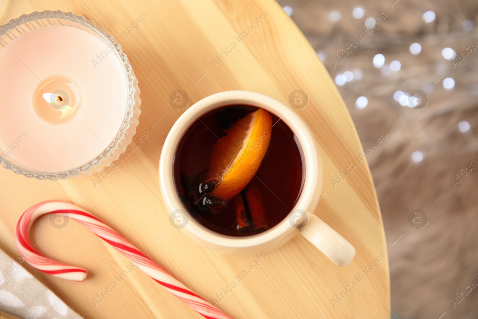 Photo of Flat lay composition with cup of hot mulled wine on wooden table. Winter drink