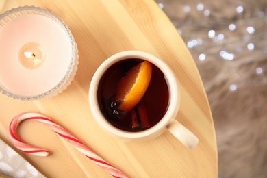 Photo of Flat lay composition with cup of hot mulled wine on wooden table. Winter drink