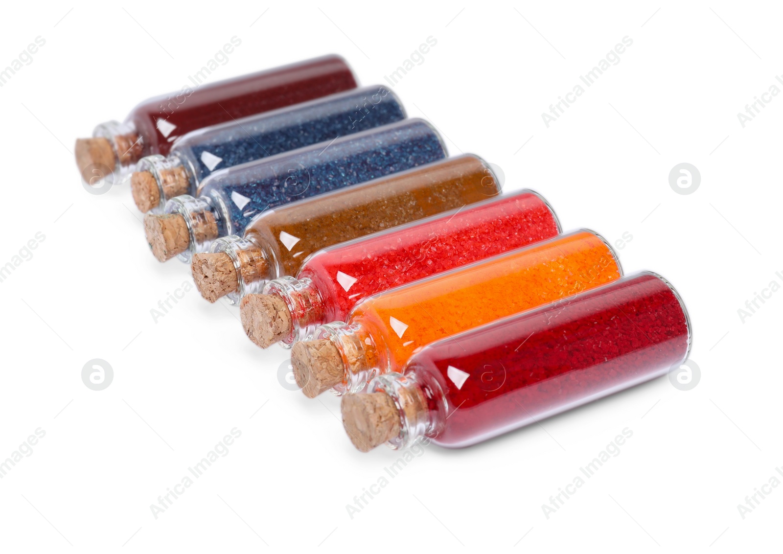 Photo of Glass bottles of different food coloring isolated on white