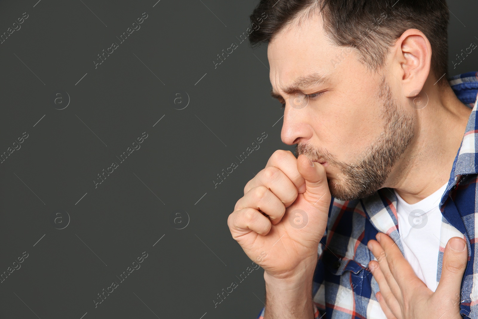 Photo of Mature man suffering from cough on dark background. Space for text
