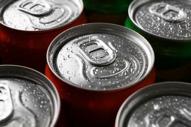 Photo of Energy drink in wet cans, closeup. Functional beverage