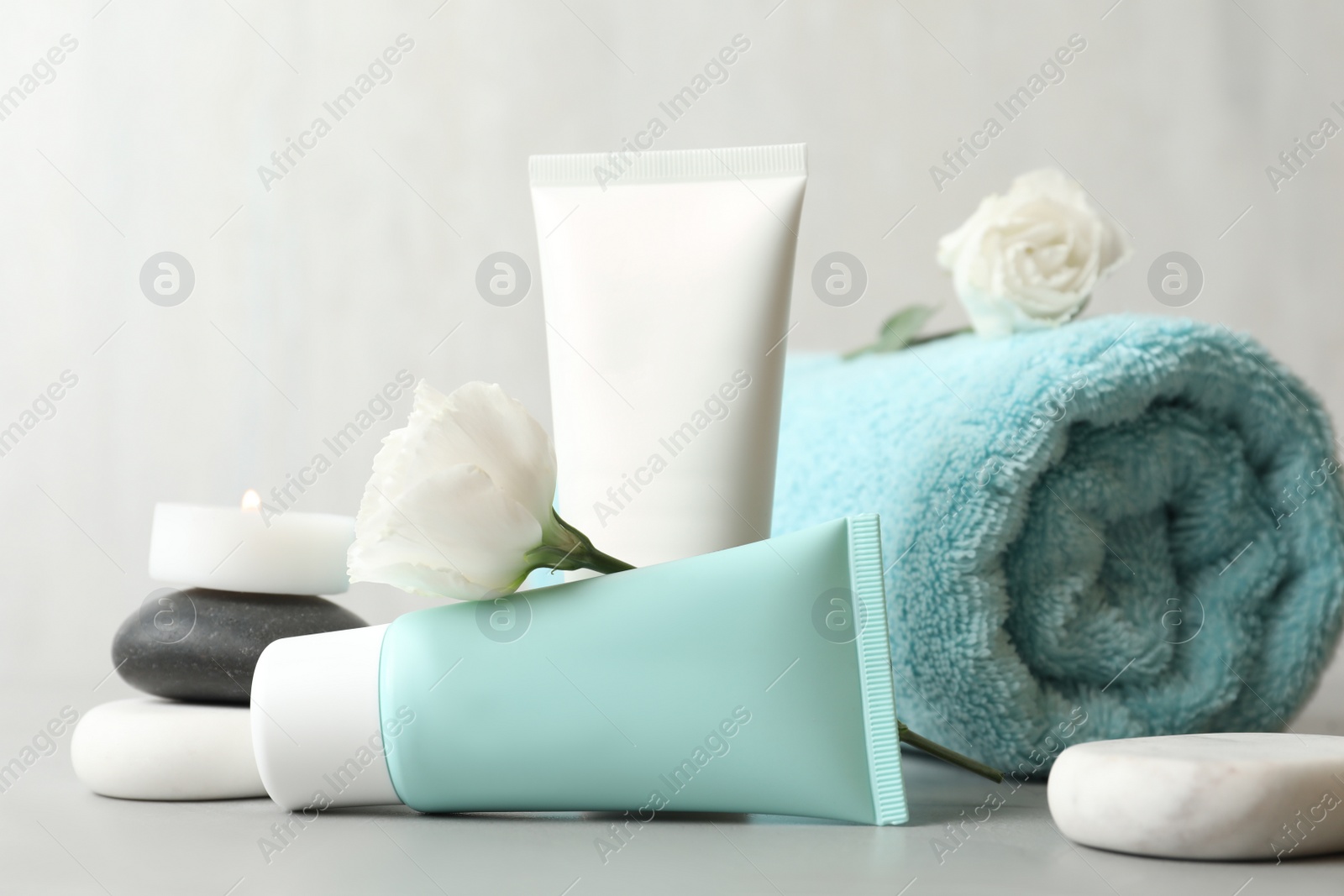 Photo of Composition with cosmetic products on light grey stone table