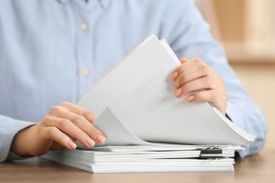 Photo of Woman working with documents at table in office, closeup