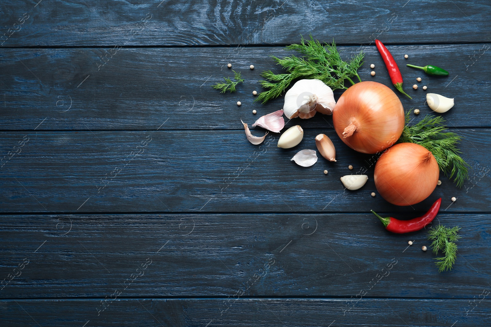 Photo of Flat lay composition with garlic, onions and dill on wooden background. Space for text