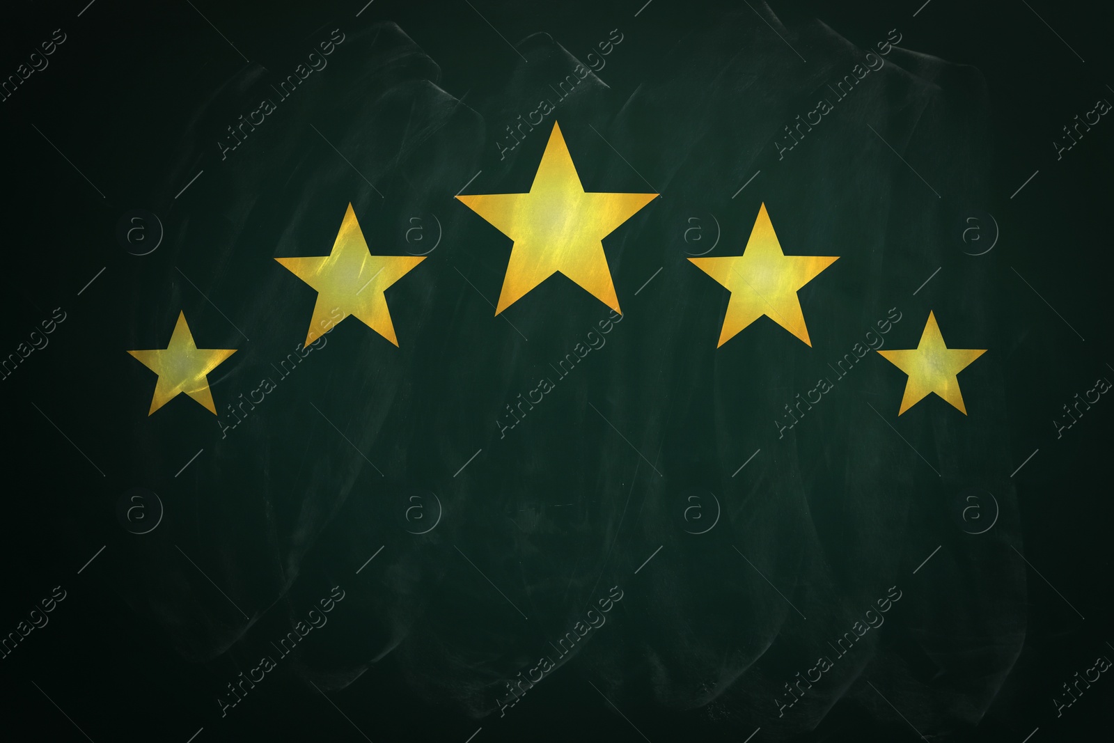 Image of Quality evaluation. Golden stars on green chalkboard